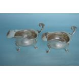 A heavy pair of silver sauce boats with card cut r