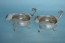A heavy pair of silver sauce boats with card cut r