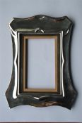 A rectangular picture frame of plain scalloped des