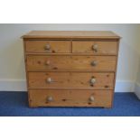 A Pine chest of five drawers with turned handles.