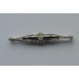 An attractive Edwardian rose diamond and onyx brooch with scroll decoration in white gold. Est. £300