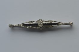 An attractive Edwardian rose diamond and onyx brooch with scroll decoration in white gold. Est. £300