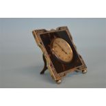 An attractive tortoiseshell dressing table clock with pierced border. London 1926. Est. £150 - £