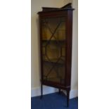 An Edwardian inlaid corner cabinet with splay legs