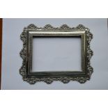 A rectangular silver picture frame decorated with