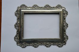 A rectangular silver picture frame decorated with