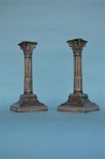 A good pair of Corinthian column candlesticks on s