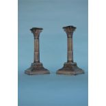 A good pair of Corinthian column candlesticks on s