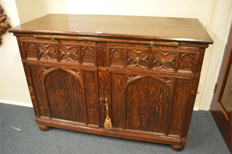 A good Oak carved gothic sideboard with brass hand