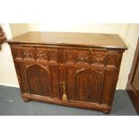 A good Oak carved gothic sideboard with brass hand