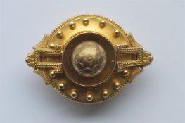 A large Victorian gold target brooch with ball decoration and locket back. Approx. 15 grams. Est. £