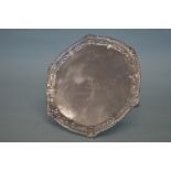 A circular waiter with scroll decorated border and