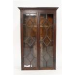 An oak bookcase enclosed by a pair of astragally glazed doors, w. 85 cm One pane glass loose,