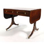 A Regency rosewood and crossbanded sofa table, the drop leaf top with two frieze drawers and