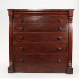 A Victorian mahogany chest fitted with five graduated long drawers beneath a disguised cushion