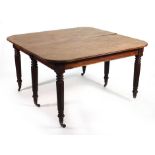 An early 19th century extending mahogany dining table, the top with rounded corners and moulded edge