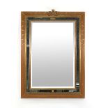 A George III-style marginal wall mirror with rectangular bevelled plate in a moulded gilt frame,