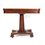 An early 19th century mahogany tea table with fold over top on a tapered support with quadruple