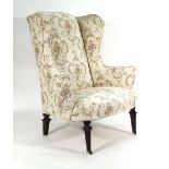 An 18th century-style wing armchair on square tapered legs Re-upholstered, structurally sound