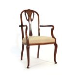 An Edwardian mahogany, strung, inlaid and part upholstered armchair with swag decorated splat on