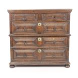 A Charles II oak chest of three graduated long and two short drawers, each with geometrically