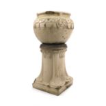 After Archibald Knox, a glazed stoneware garden urn, the vase shaped body moulded with a frieze of