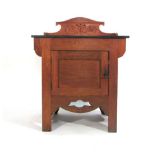 An Arts & Crafts oak marble top washstand with carved and pierced decoration, w. 76 cm, h. 96 cm, d.