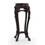 A late 19th/early 20th century Chinese carved jardiniere stand, the octagonal rouge marble surface