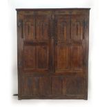 A 17th century and later panelled oak cupboard, the two doors with moulded decoration on stile