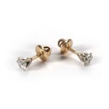 A pair of yellow and white metal stud ea