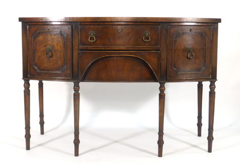 An 18th century-style mahogany and crossbanded bow fronted sideboard with an arrangement of two