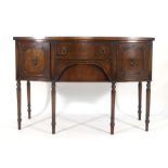 An 18th century-style mahogany and crossbanded bow fronted sideboard with an arrangement of two