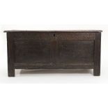 An 18th century panelled oak coffer with a moulded frieze on square stiles, l. 125 cm CONDITION