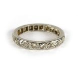 A diamond set white metal eternity ring, ring size N/O CONDITION REPORT: One stone missing