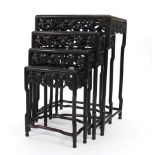 A set of late 19th century Chinese rosewood quartetto tables with vine pierced friezes, max w. 52 cm