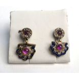 A pair of diamond set and enamel decorated screw-type pendant earrings  CONDITION REPORT: one with