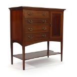 An Edwardian mahogany and inlaid music cabinet, the four drop-down drawers beside a cupboard, on