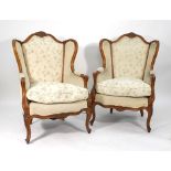 A pair of Louis XV-style walnut and part upholstered open armchairs on cabriole feet CONDITION