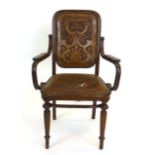 A Thonet bentwood armchair with stamped leather back and seat on reeded front legs
* original