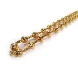 A yellow metal openwork ball link neckla