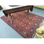 A Turkoman rug of Tekke design with a red ground, 180 x 127 cm, together with four other rugs,