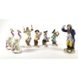 A group of four Meissen-style monkey band figures, max h. 15.5 cm, another figure modelled as a