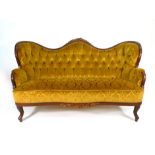 A 19th century Rococo-style mahogany and upholstered sofa on splayed legs with pad feet CONDITION