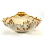 A Royal Worcester dish of leaf shaped form, typically gilt decorated with floral sprays on a blush