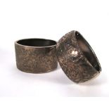 Two florally engraved silver cuff type b