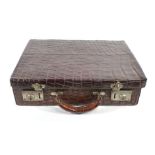 An early 20th century crocodile skin briefcase, w. 41 cm CONDITION REPORT: Wear commensurate with