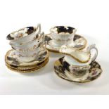 A late 19th century Coalport part tea service, typically gilt decorated with floral sprays within