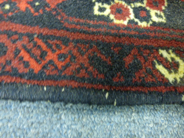 A Turkoman-style runner of Tekke design, the red ground within a matching border, 300 x 80 cm - Image 7 of 8