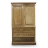 A 19th century ash linen press, the two doors over two short and two long graduated drawers on a