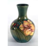 A Moorcroft bottle vase decorated with freesias on a pale green ground, h. 12 cm CONDITION REPORT: